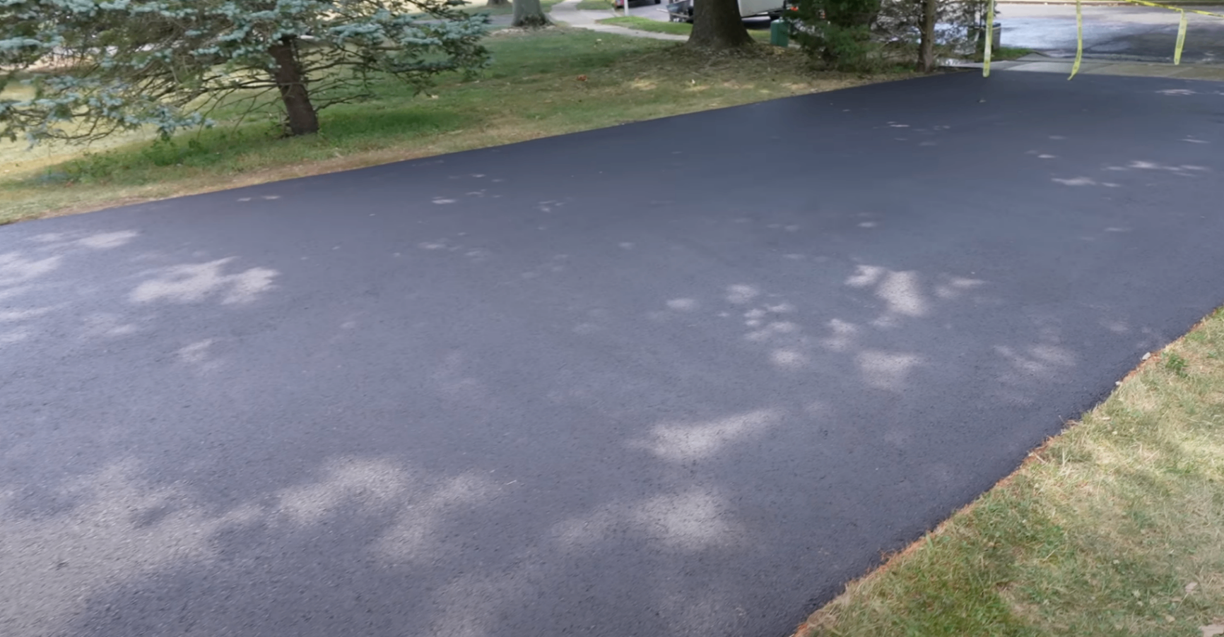 technician applying resurfacing overlay to a salt-scaled Columbus driveway