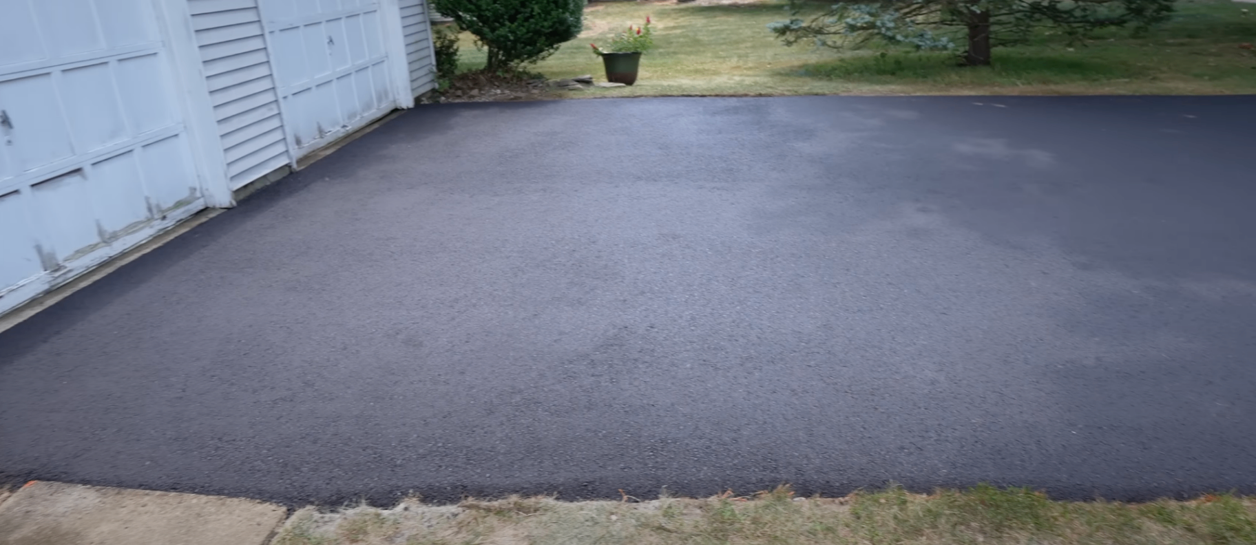 routed crack being filled with flexible sealant on a Columbus driveway before winter
