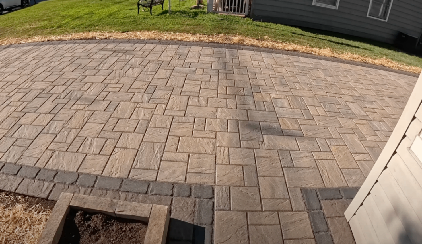 finisher cutting control joints into a fresh driveway with an early-entry saw
